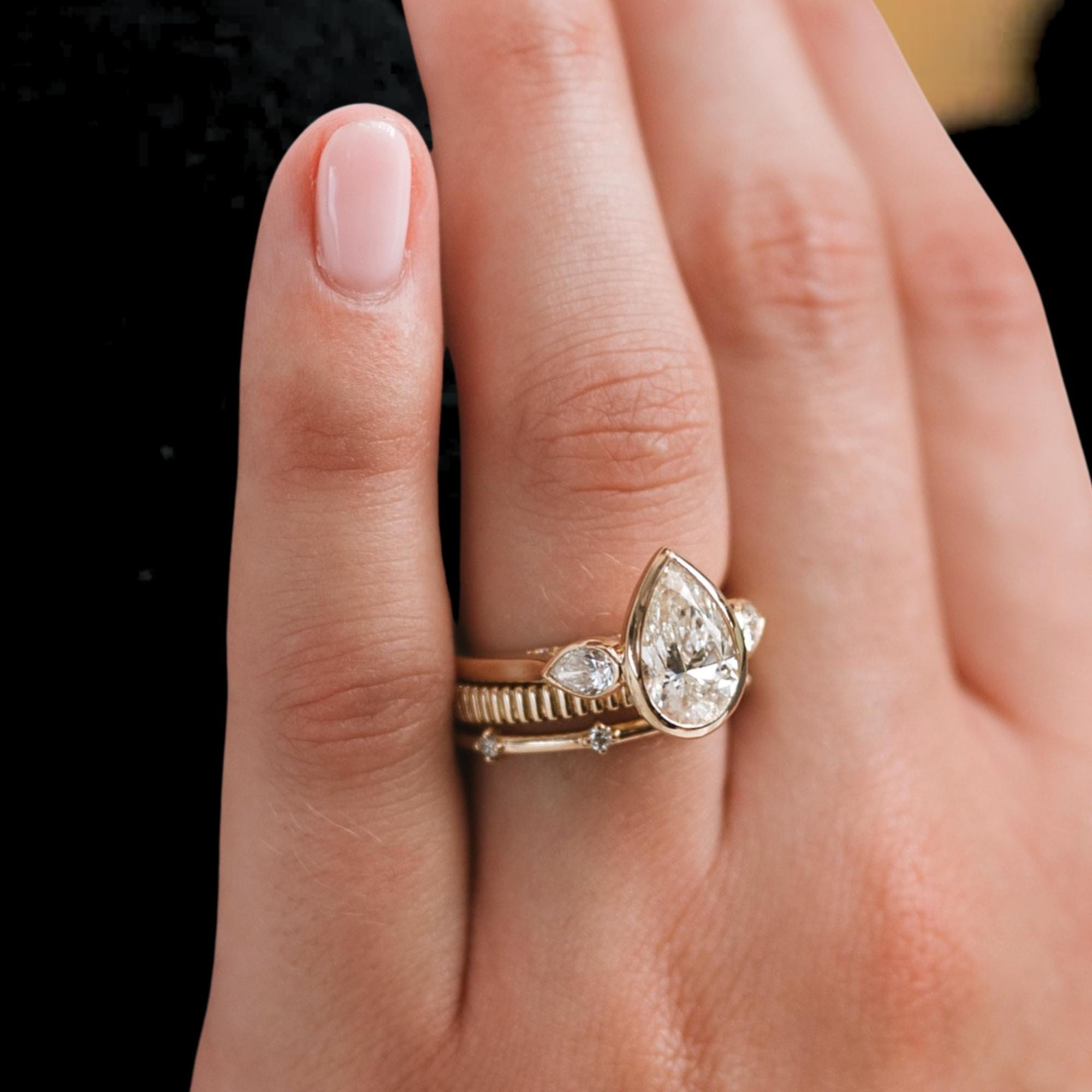 2 Carat Pear Cut Lab Created Diamond Bezel Set Three Stone Ring With Hidden Halo
