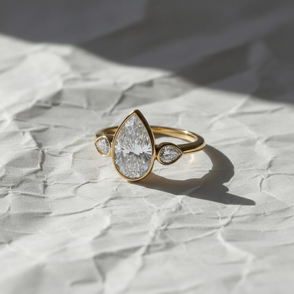 2 Carat Pear Cut Lab Created Diamond Bezel Set Three Stone Ring With Hidden Halo