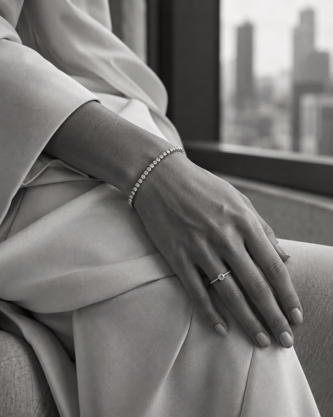 ÉLYSÉA campaign detail of diamond jewellery worn with ivory tailoring