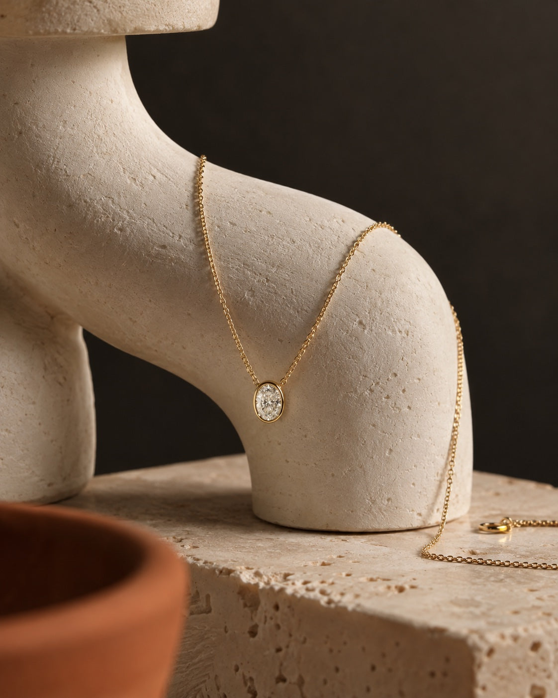 ÉLYSÉA campaign pendant on an ivory sculpture